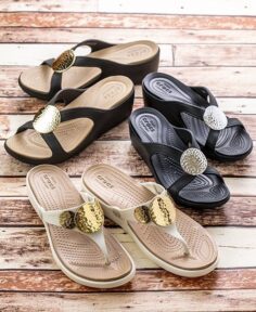three pairs of Crocs sandals and wedges in black, beige, and white