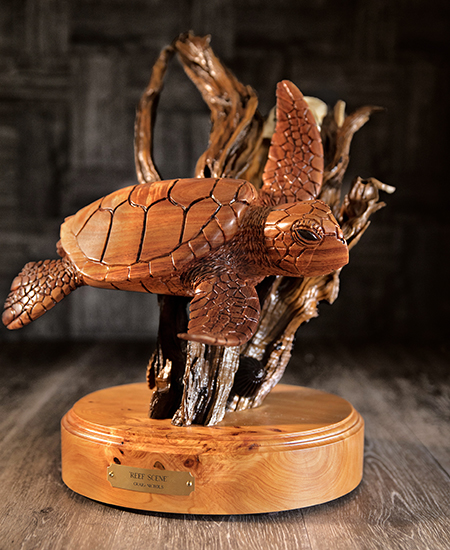 Hawaiian sea turtle (honu) carved out of Koa wood on a stand, at Martin & MacArthur at the Moana Surfrider