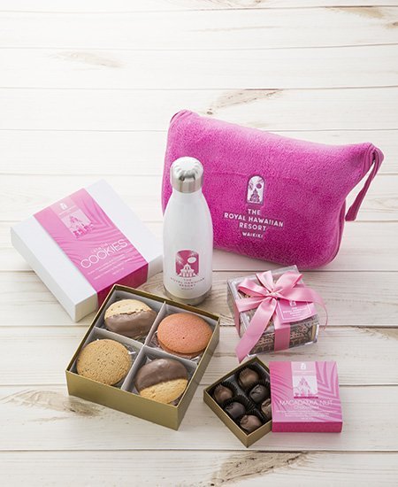 plush pink Royal Hawaiian cosmetic bag, Royal Hawaiian box of cookies and chocolate-dipped macadamia nuts