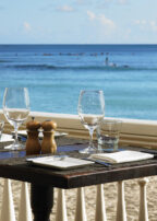 daytime view of a table setting in front of Waikiki Beach at the beachhouse at the moana