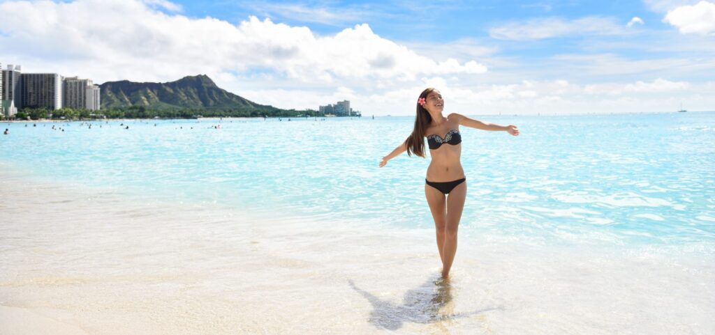 girl standing on Waikiki beach on a sunny day