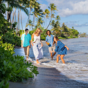SW Angels by the Sea Hawaii, group of two young men and two young women having fun on a sandy ocean coastline