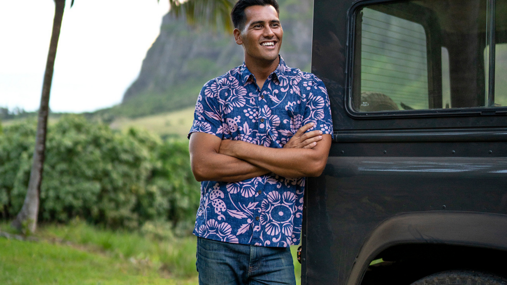 Male standing next to a Jeep wearing a blue Kahala aloha shirt