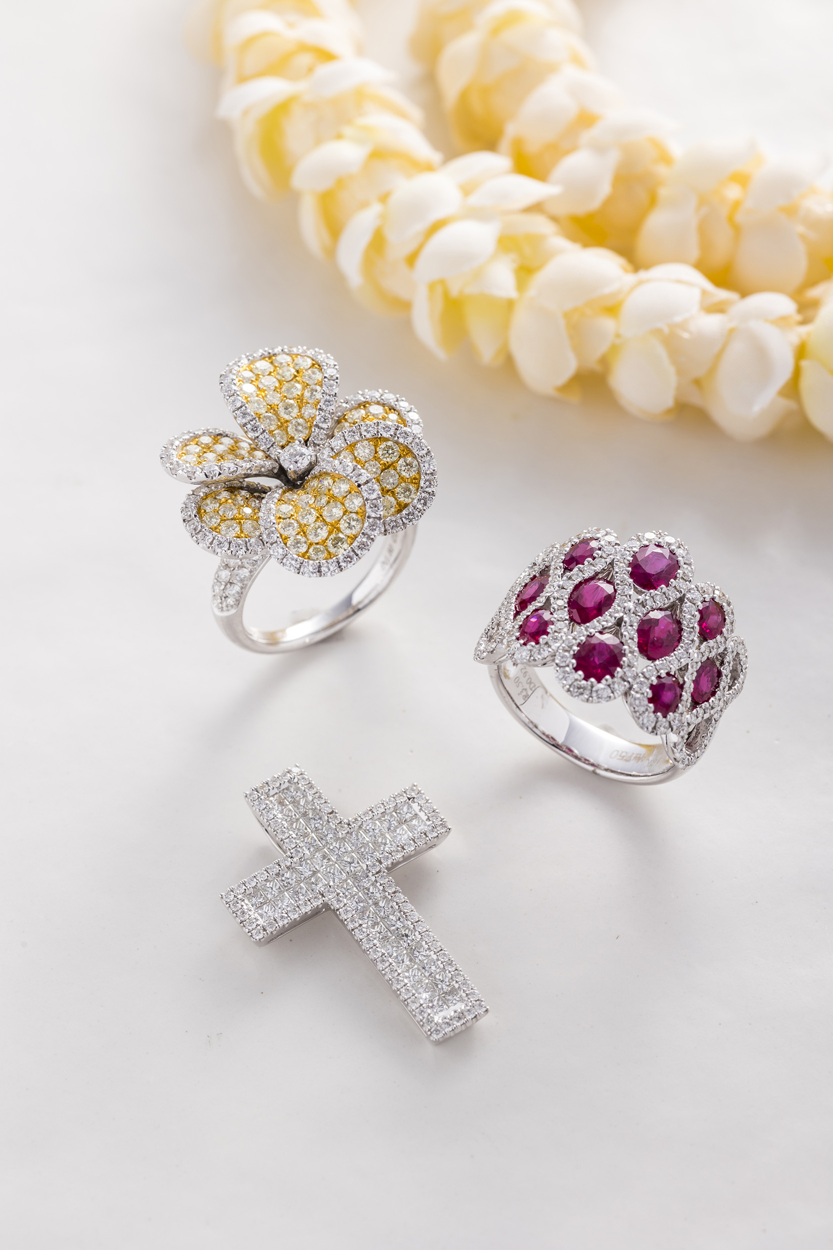 two white gold rings and one white gold cross pendant