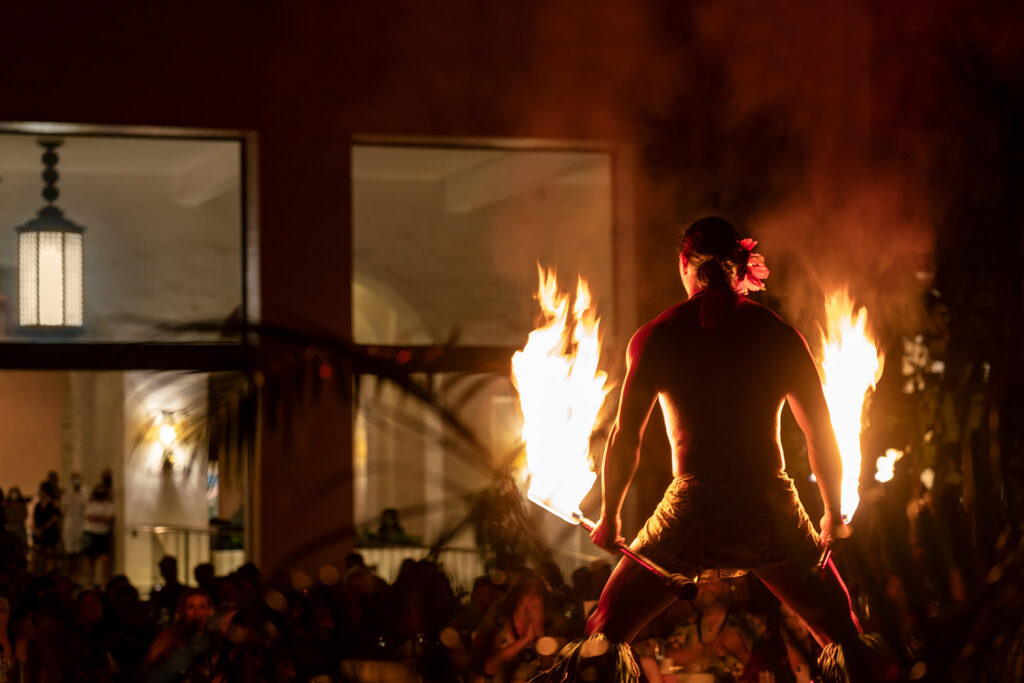 'Aha 'Aina fire dancer holding two flaming rods