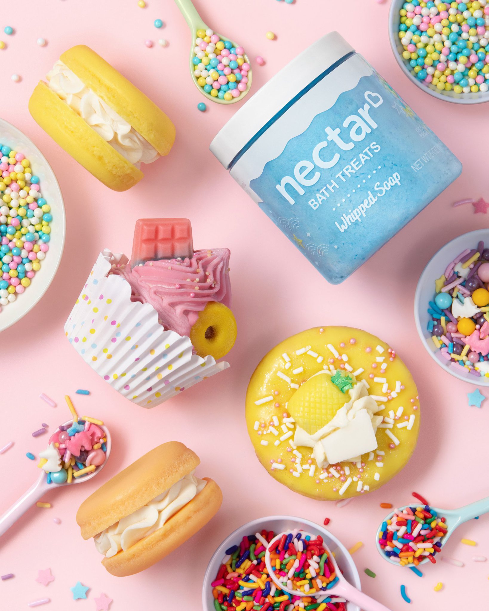 Assorted bath soaps and bath bombs that look like cupcakes and donuts, by Nectar Bath Treats